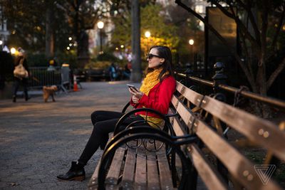 Adi Robertson holding a OnePlus phone as a controller for the Nreal Light glasses