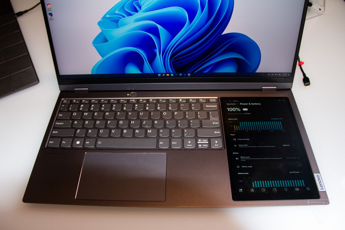 The Lenovo ThinkBook plus Gen 3 keyboard seen from above. The primary screen displays a blue swirl on a white background.