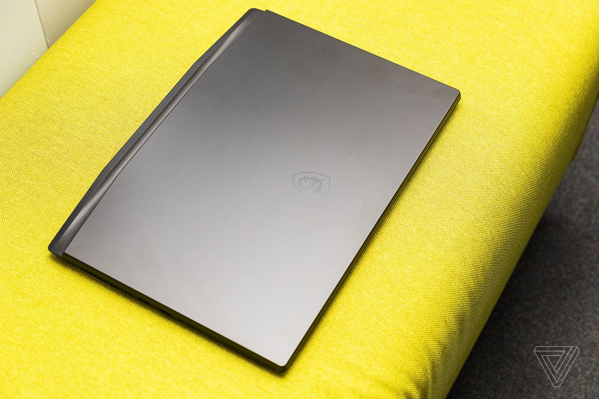 The MSI GS77 Stealth closed on a yellow fabric bench seen from above.